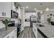 Modern kitchen featuring granite counters, stainless appliances, and sleek white cabinetry for a chef's paradise at 191 Marley Blue Dr., Little River, SC 29566