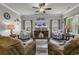 Inviting living room with a ceiling fan, comfortable seating, and lots of light creating a relaxing atmosphere at 191 Marley Blue Dr., Little River, SC 29566