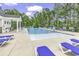 Community pool with lounge chairs and umbrellas, perfect for relaxing on a sunny day at 191 Marley Blue Dr., Little River, SC 29566