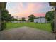 Private backyard featuring lush landscaping, green lawn, mature trees and a white picket fence at 196 La Patos Dr., Myrtle Beach, SC 29588