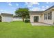 Large backyard featuring green lawn, storage building, privacy fence, and concrete patio, perfect for outdoor enjoyment at 196 La Patos Dr., Myrtle Beach, SC 29588