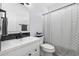 Modern bathroom with white vanity and black fixtures with decorative shower curtain at 196 La Patos Dr., Myrtle Beach, SC 29588