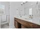 This bathroom features a wood vanity, double sinks, and a glass-enclosed shower at 196 La Patos Dr., Myrtle Beach, SC 29588