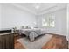Comfortable bedroom with tray ceiling, hardwood floors, and bright window at 196 La Patos Dr., Myrtle Beach, SC 29588