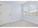 Bright, vacant room with gray tile flooring, a window, and light blue walls at 196 La Patos Dr., Myrtle Beach, SC 29588