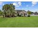 Charming single-story home featuring a well-manicured lawn, lush palm trees, and tasteful landscaping at 196 La Patos Dr., Myrtle Beach, SC 29588