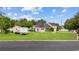 Inviting curb appeal with a well-manicured lawn, lush landscaping, white picket fence and large storage shed at 196 La Patos Dr., Myrtle Beach, SC 29588