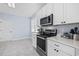 Well-appointed kitchen features stainless steel appliances, sleek countertops, and white cabinets at 196 La Patos Dr., Myrtle Beach, SC 29588