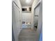 Hallway with mudroom style bench and a doorway to the laundry room is an organized and functional space at 200 Ponte Vedra Dr., Murrells Inlet, SC 29576