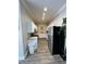 Functional galley kitchen with white cabinets, neutral countertops, and modern stainless steel appliances at 200 Ponte Vedra Dr., Murrells Inlet, SC 29576