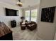 Cozy living room with comfortable leather seating, a mounted TV, and a view of the outdoors through the window at 200 Ponte Vedra Dr., Murrells Inlet, SC 29576