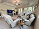 Spacious living room with lots of natural light from plentiful windows is furnished with comfortable, neutral couches at 200 Ponte Vedra Dr., Murrells Inlet, SC 29576