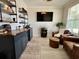Inviting living room with custom bar area, comfortable seating, a mounted TV, and natural light at 200 Ponte Vedra Dr., Murrells Inlet, SC 29576