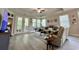 Bright living room boasts white couches, neutral walls and floor, and French doors leading to a porch at 200 Ponte Vedra Dr., Murrells Inlet, SC 29576