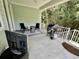 Covered porch with a grill and two chairs on an outdoor rug at 200 Ponte Vedra Dr., Murrells Inlet, SC 29576