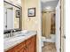Bathroom featuring granite countertops, a wooden vanity, and a tiled shower at 201 Westleton Dr. # 10-I, Myrtle Beach, SC 29572