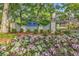 Inviting entrance to West Hyde Park, with colorful flowers and mature trees creating a welcoming atmosphere at 201 Westleton Dr. # 10-I, Myrtle Beach, SC 29572