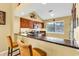 A cozy kitchen featuring a breakfast bar with granite countertop and wooden cabinets at 201 Westleton Dr. # 10-I, Myrtle Beach, SC 29572