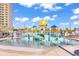 Bright splash pool area with fun water features, palm trees and upscale condo building in the background on a bright day at 201 Westleton Dr. # 10-I, Myrtle Beach, SC 29572