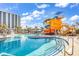 Large outdoor pool area with a tall water slide and tower, lounge seating, and palm trees, with a high-rise condo at 201 Westleton Dr. # 10-I, Myrtle Beach, SC 29572