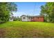 This backyard features a green lawn with a detached garage and trees surrounding the property at 203 Longwood Ln., Conway, SC 29527