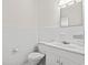 Bright bathroom featuring a white toilet, sink, and tile walls for a clean and classic look at 203 Longwood Ln., Conway, SC 29527