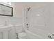 Bathroom featuring a pedestal sink, a modern showerhead, and a pristine white bathtub at 203 Longwood Ln., Conway, SC 29527