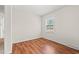 This is a bedroom with wood floors and a large window, providing plenty of natural light and a view at 203 Longwood Ln., Conway, SC 29527