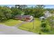 A well-maintained brick home with an expansive lawn, driveway, carport, and detached garage at 203 Longwood Ln., Conway, SC 29527