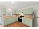 Updated kitchen with stainless steel appliances and light green cabinets and wood counters at 203 Longwood Ln., Conway, SC 29527