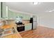 Kitchen featuring stainless appliances, wood countertops, and light green cabinets at 203 Longwood Ln., Conway, SC 29527
