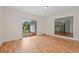 Bright living room with sliding glass doors leading to the backyard and view to kitchen at 203 Longwood Ln., Conway, SC 29527