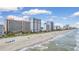 Wide sandy beach with resorts in the background under a blue sky at 2207 S Ocean Blvd. # 1517, Myrtle Beach, SC 29577