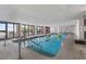 Bright indoor pool area with lounge chairs and ocean view through glass doors at 2207 S Ocean Blvd. # 1517, Myrtle Beach, SC 29577