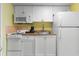 Efficient kitchenette with microwave, coffeemaker, sink and white cabinets at 2207 S Ocean Blvd. # 1517, Myrtle Beach, SC 29577