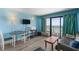 Comfortable living room features wood floors, a sofa, and a balcony with ocean views at 2207 S Ocean Blvd. # 1517, Myrtle Beach, SC 29577