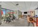 This is an ocean front lounge area with tables, chairs, a bar, and large windows with ocean views at 2207 S Ocean Blvd. # 1517, Myrtle Beach, SC 29577