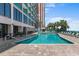 Enjoy the outdoor pool surrounded by tables, lounge chairs, and tropical landscaping at 2207 S Ocean Blvd. # 1517, Myrtle Beach, SC 29577