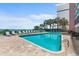 Inviting outdoor pool with lounge chairs, palm trees, and views of the ocean at 2207 S Ocean Blvd. # 1517, Myrtle Beach, SC 29577