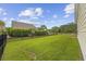 Expansive backyard with lush green grass, a privacy fence, and ample space for outdoor activities and relaxation at 2300 Lark Sparrow St., Myrtle Beach, SC 29577