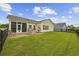 Charming backyard featuring a screened patio, outdoor grill, and well-maintained lawn at 2300 Lark Sparrow St., Myrtle Beach, SC 29577