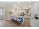 Bright kitchen features a large island with granite countertops and stylish seating at 2300 Lark Sparrow St., Myrtle Beach, SC 29577