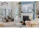 Close up of the living room fireplace with decorations, large windows and seating at 2300 Lark Sparrow St., Myrtle Beach, SC 29577