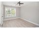 Bright bedroom featuring a ceiling fan, wood-look flooring, and a window with natural light at 231 Marbella Dr., Murrells Inlet, SC 29576