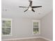 Light-filled bedroom featuring a ceiling fan and two large windows with natural light at 231 Marbella Dr., Murrells Inlet, SC 29576