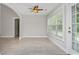 Cozy dining area with large windows, neutral walls, and a ceiling fan at 231 Marbella Dr., Murrells Inlet, SC 29576