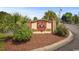The International Club entrance is marked by beautiful landscaping, including palm trees, flowers, and mature shrubbery at 231 Marbella Dr., Murrells Inlet, SC 29576