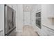View down hallway with stainless steel refrigerator and appliances at 231 Marbella Dr., Murrells Inlet, SC 29576