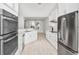 Open concept kitchen featuring modern appliances, tile flooring, and quartz countertops at 231 Marbella Dr., Murrells Inlet, SC 29576