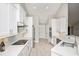 Modern kitchen features white cabinets, stainless steel appliances, and tile flooring at 231 Marbella Dr., Murrells Inlet, SC 29576